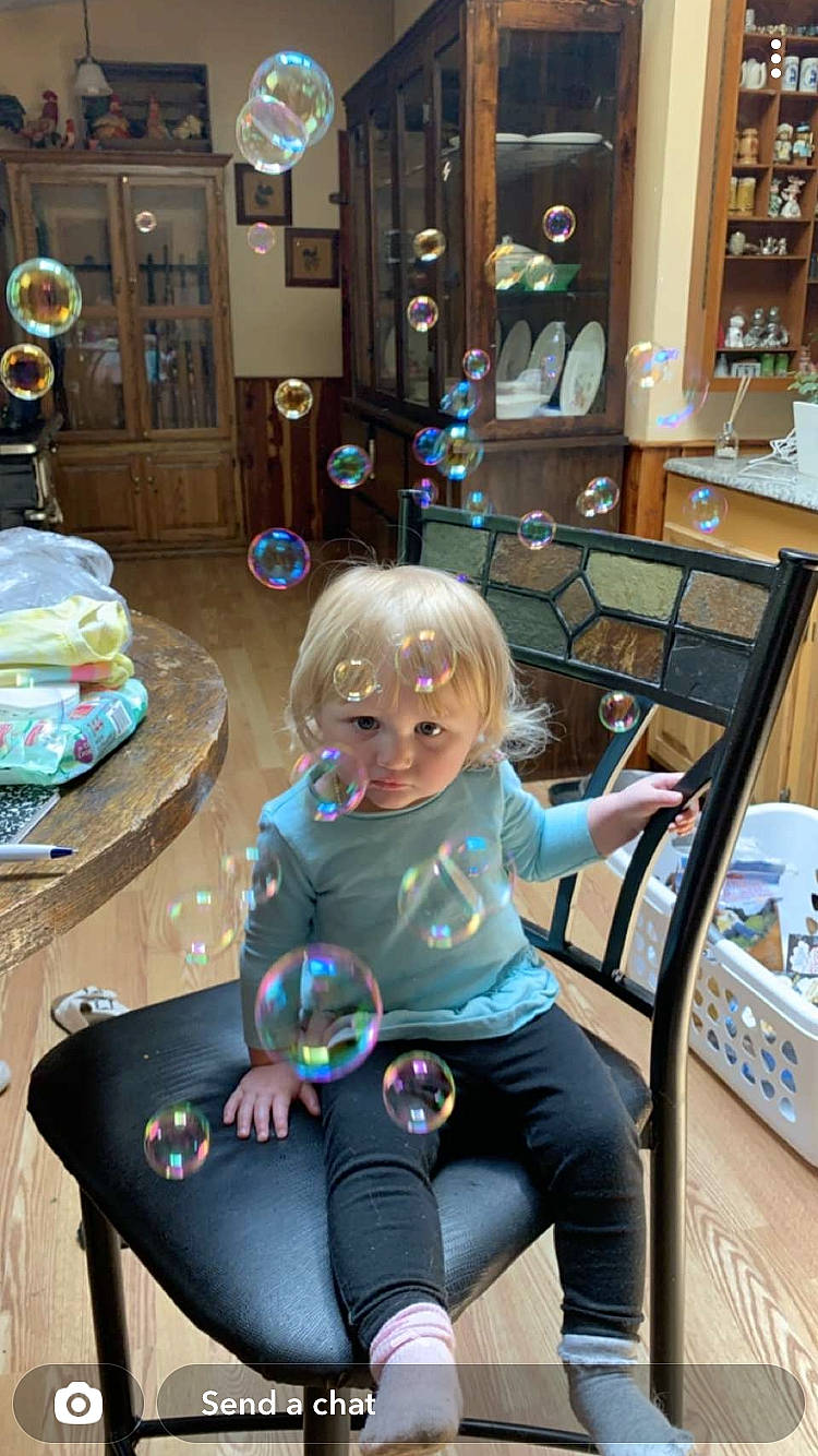 Jazelle is registered to the contest to win money with this photo: blond, chair, child, fun, hairstyle, human_body, human_leg, knee, lap, leg, leisure, person, photograph, picture_frame, public_space, room, sitting, snapshot, standing, thigh