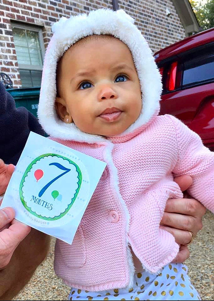 Aleigha is registered to the contest to win money with this photo: baby, baby_products, baby_toddler_clothing, child, headwear, outerwear, person, pink, skin, toddler