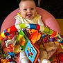 baby, child, smiling, happy, indoor, toy, colorful, playmat, seat, infant, clothing, white_socks, book, soft_toys, face, person, cute, playtime, bright, cheerful