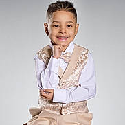 Jexiel is registered to the contest to win money with this photo: background, bow_tie, boy, braided_hair, child, cute, elegant, fashion, formal_wear, happy, indoor, person, portrait, pose, seated, shirt, smile, studio, suit, young