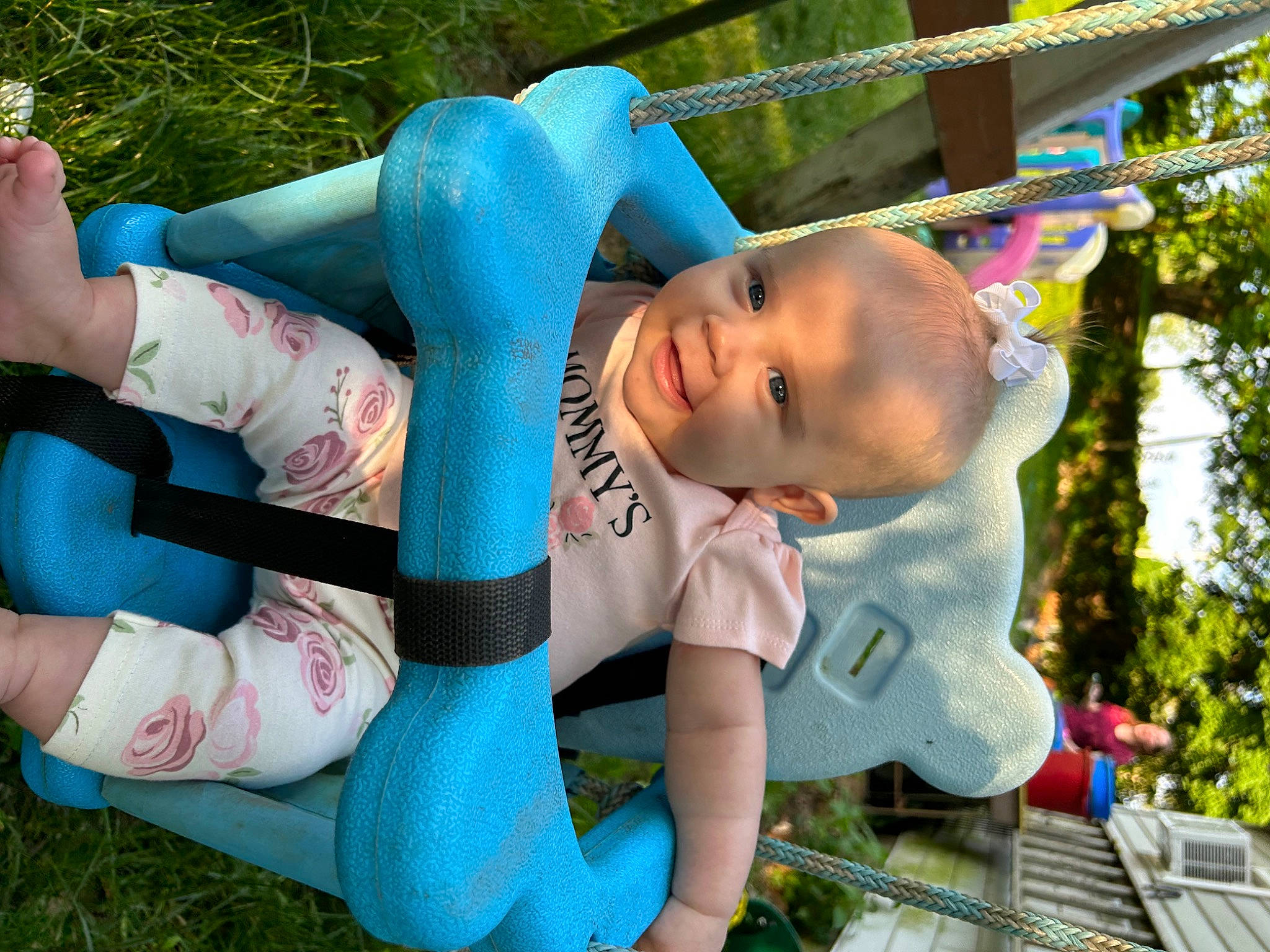 Adalynn is registered to the contest to win money with this photo: blurred, child, electric_blue, fun, grass, happy, human_body, human_leg, leisure, outdoor_play_equipment, people_in_nature, person, photograph, plant, play, recreation, snapshot, sock, thigh, toddler
