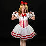 Grayleigh is registered to the contest to win money with this photo: child, girl, ballet, tutu, dance, costume, red_bow, white_dress, posing, studio, portrait, smiling, young, performance, dance_shoes, gloves, red_and_white, standing, black_background, fashion