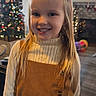 Grayleigh is registered to the contest to win money with this photo: child, christmas_tree, cute, decorations, dress, face, floor, furniture, girl, happy, holiday, home, indoor, lights, living_room, long_hair, portrait, smiling, sweater, window