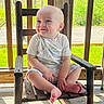 James joined the competition — help win amazing prizes! baby, child, smile, blue_eyes, tshirt, shorts, barefoot, rocking_chair, wood, porch, sunlight, greenery, outdoor, nature, happy, cute, infant, person, sitting, daylight