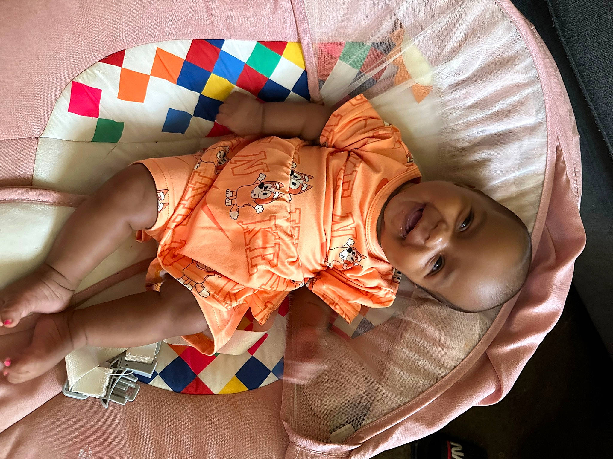 Abrielle is registered to the contest to win money with this photo: baby, baby_products, chest, child, circle, comfort, fashion_accessory, flesh, happy, headgear, human_leg, joy, linens, nail, orange, pattern, peach, person, sitting, sunglasses