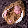 newborn, baby, sleeping, knitwear, bunny_ears, fur_blanket, cozy, cute, infant, portrait, soft_texture, wrapped, peaceful, pink_skin, small_hands, head, child, warm, resting, adorable