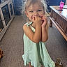 Echo is registered to the contest to win money with this photo: child, toddler, girl, portrait, smiling, standing, dress, green_dress, pink_shoes, clogs, indoor, home, furniture, table, sippy_cup, sandals, carpet, blonde_hair, hair_bun, playful