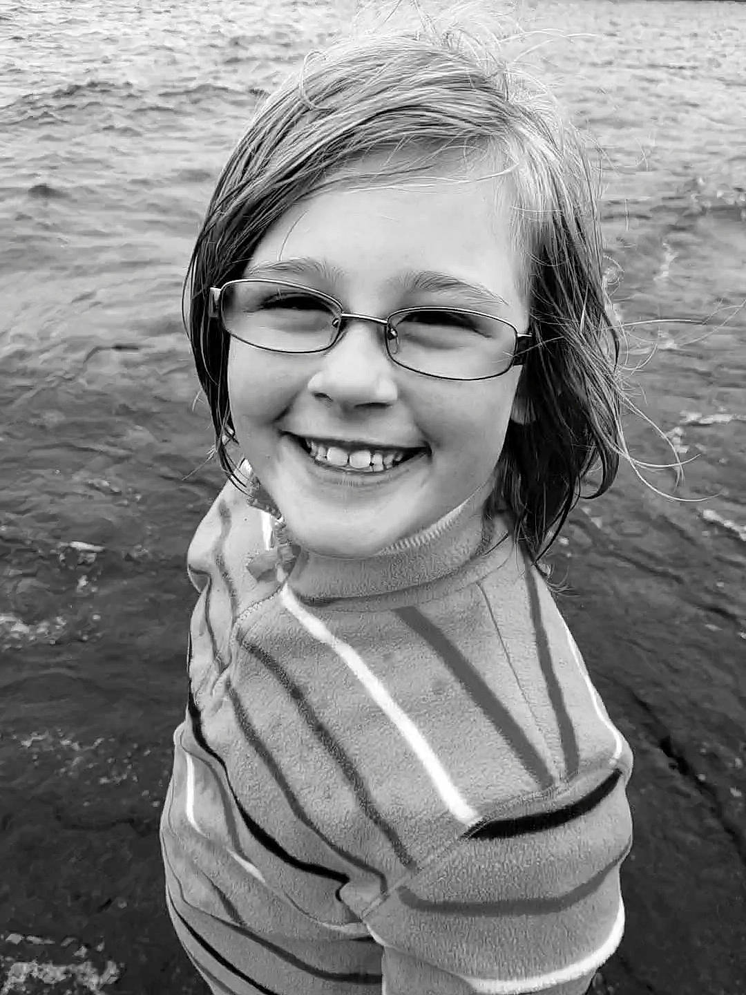 Danyelle is registered to the contest to win money with this photo: black_and_white, eye, eyewear, face, facial_expression, flash_photography, glasses, happy, head, human_body, joy, lip, mammal, nose, organ, person, smile, standing, style, vision_care