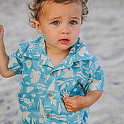 Mason joined the competition — help win amazing prizes! toddler, child, beach, sand, blue_shirt, curly_hair, outdoor, summer, portrait, casual_clothing, cute, young_child, expression, person, sunlight, vacation, nature, standing, fashion, small_person