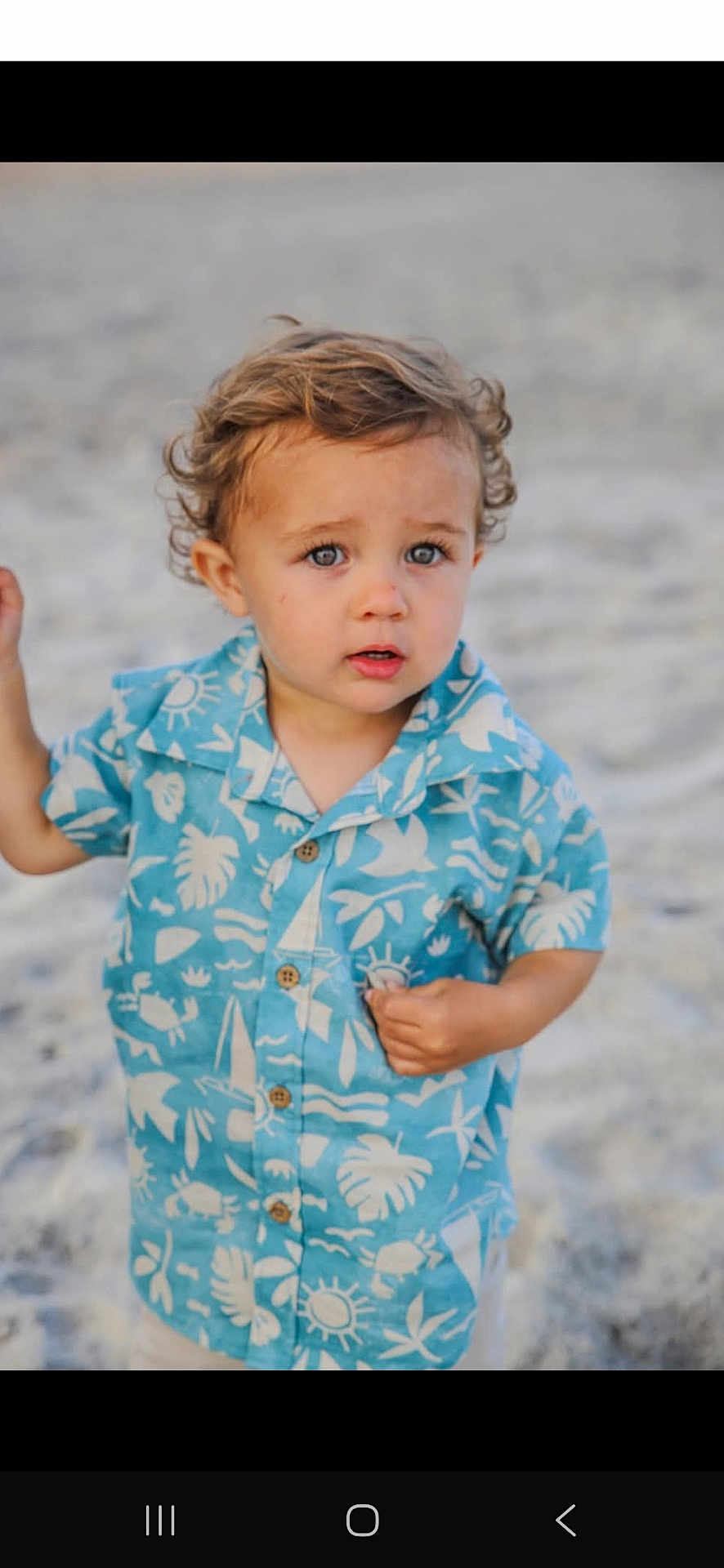 Mason joined the competition — help win amazing prizes! toddler, child, beach, sand, blue_shirt, curly_hair, outdoor, summer, portrait, casual_clothing, cute, young_child, expression, person, sunlight, vacation, nature, standing, fashion, small_person