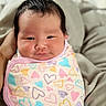 Juni Kim joined the competition — help win amazing prizes! baby, infant, swaddle, heart_pattern, smile, face, cute, newborn, wrapped, soft, cozy, person, child, indoors, closeup, skin, hair, pink, pastel_colors, comfortable