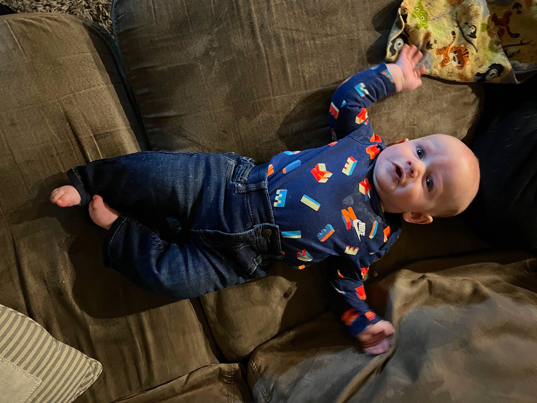 Korbyn is registered to the contest to win money with this photo: baby, child, comfort, cool, couch, denim, flooring, fun, grass, hat, leg, outerwear, person, plant, sitting, sneakers, suit, textile, toddler, tree