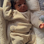 Pharell a rejoint le concours — aidez-le/la à gagner de superbes lots ! baby, beige, blanket, child, comfort, cozy, curly_hair, cute, face, indoor, infant, knitwear, newborn, person, plush, portrait, resting, sleepwear, soft_texture, warm