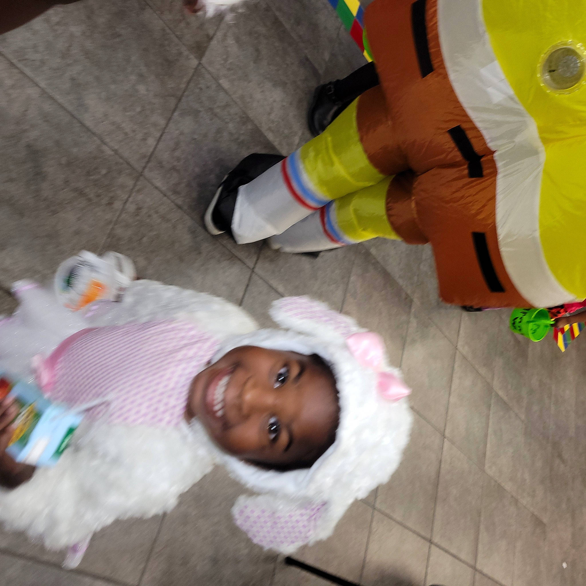 Iyana joined the competition — help win amazing prizes! baby_products, child, costume, flooring, fun, happy, headwear, human_leg, joy, person, personal_protective_equipment, plastic, play, plush, room, smile, sock, stuffed_toy, toddler, toy
