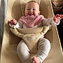 Beverly joined the competition — help win amazing prizes! baby, baby_seat, child, clothing, comfort, cute, ergobaby, face, furniture, happy, indoor, infant, joy, person, pink_bib, ribbed_pants, seat, sitting, smiling, tongue_out