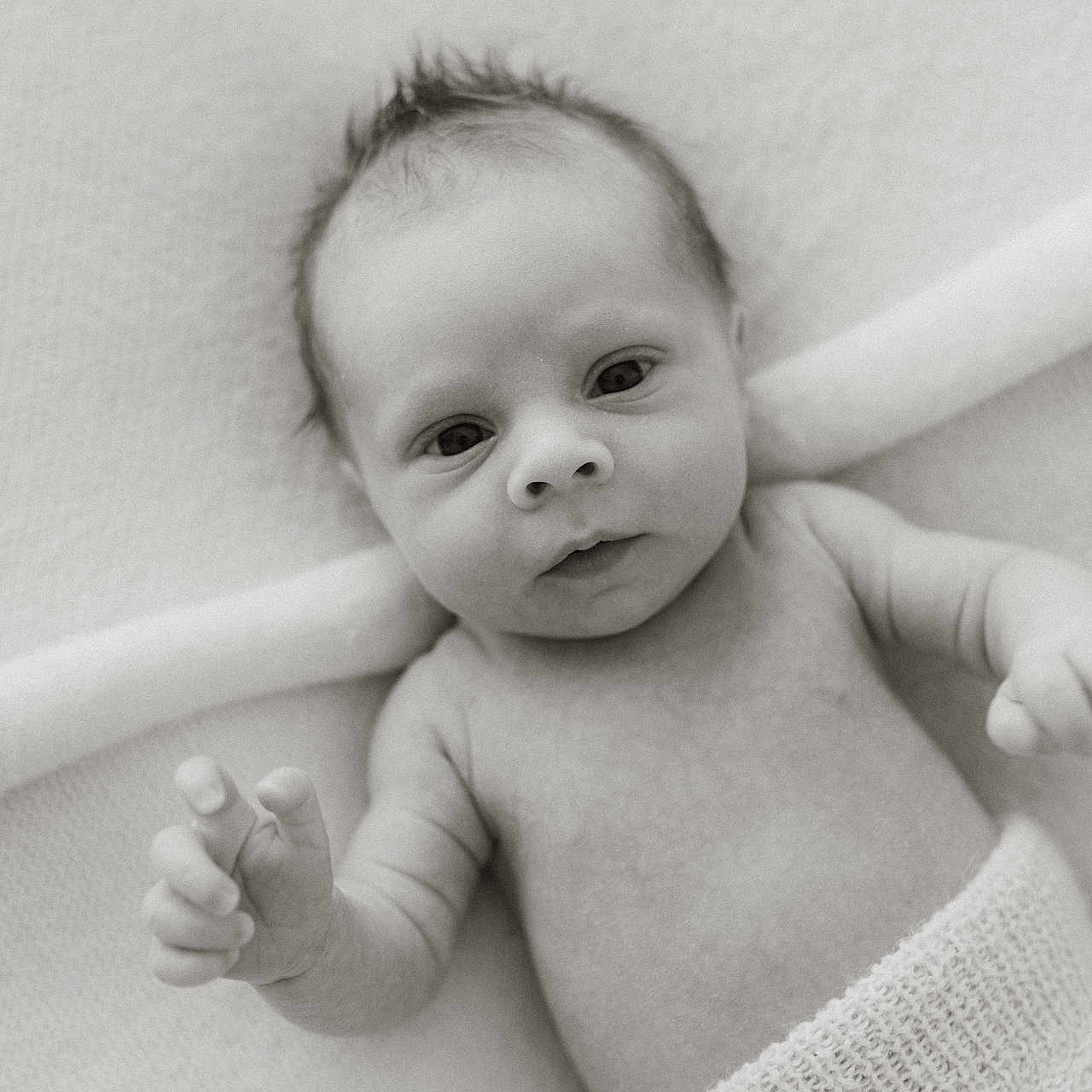 Harri joined the competition — help win amazing prizes! baby, black_and_white, blanket, child, closeup, curious_eyes, cute, expression, face, infant, knitted_cloth, lying_down, monochrome, newborn, peaceful, portrait, skin, small_hands, soft_texture, tiny_fingers