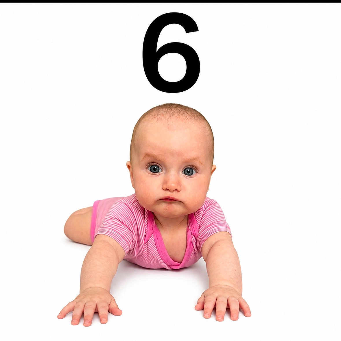Lilea is registered to the contest to win money with this photo: baby, infant, crawling, pink_clothing, onesie, blue_eyes, number_six, white_background, child, cute, portrait, hands, curious, expression, skin, head, face, young, studio_photo, isolated