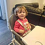 Stella joined the competition — help win amazing prizes! toddler, child, high_chair, curly_hair, pink_sweater, heart_pattern, smiling, indoor, living_room, leather_couch, seat_belt, table, flooring, person, cute, happy, baby, furniture, home, young_child