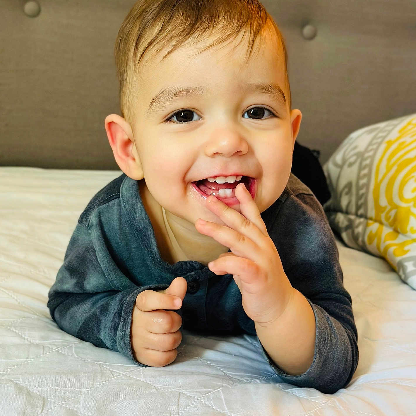 Nycolas joined the competition — help win amazing prizes! baby, babylaughing, bed, biting, bodypart, eating, face, finger, food, furniture, hand, happy, head, mouth, person, photography, portrait, sitting, smile, teeth