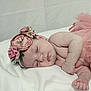 baby, sleeping, flower_headband, pink_tutu, soft_blanket, newborn, peaceful, cute, infant, portrait, skin, hand, face, closed_eyes, resting, adorable, child, tender, lying_down, soft_lighting