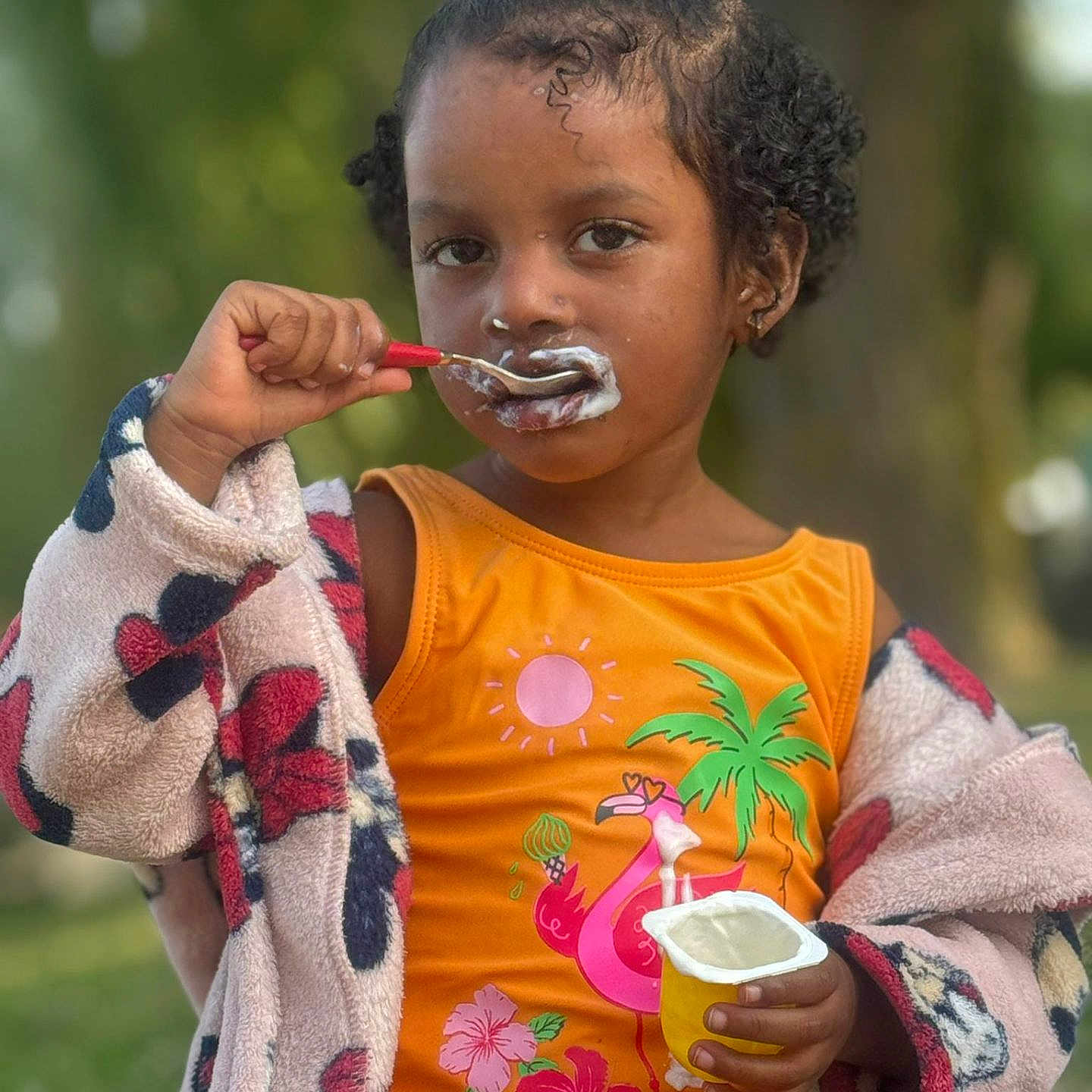 Eivana participe au concours pour gagner de l'argent avec cette photo : biting, child, cream, cup, cutlery, dessert, disposablecup, eating, face, female, food, girl, hair, happy, head, icecream, person, sitting, smile, spoon