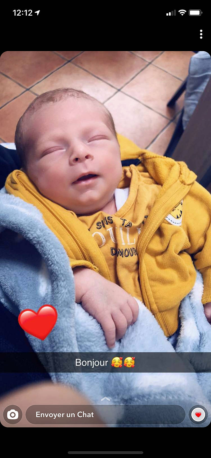 Léo a rejoint le concours — aidez-le/la à gagner de superbes lots ! baby, baby_products, baby_toddler_clothing, carmine, cheek, child, comfort, facial_expression, finger, fun, gesture, happy, interaction, jacket, mouth, nose, orange, person, sitting, skin