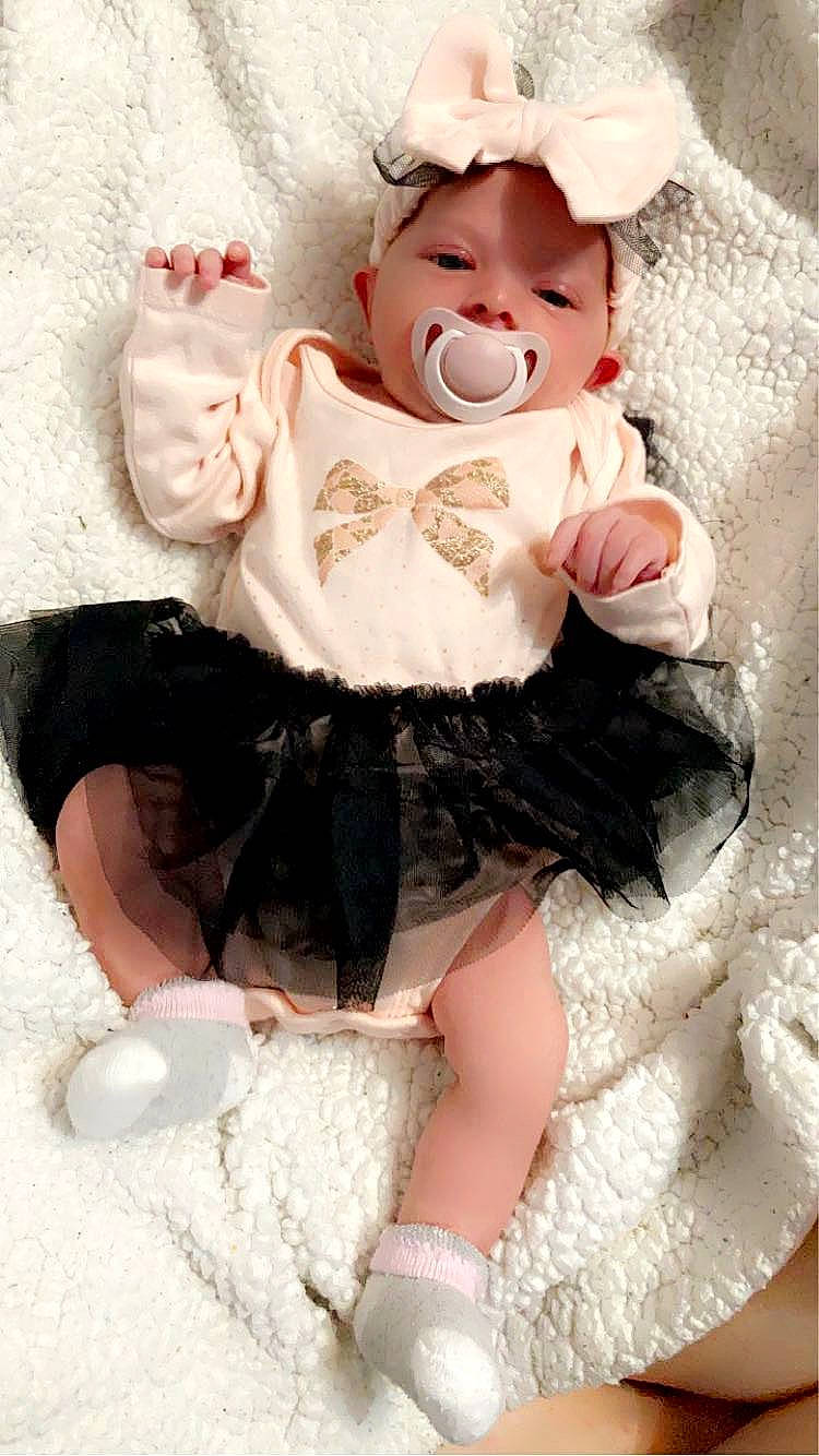 Ella-mae is registered to the contest to win money with this photo: baby_toddler_clothing, bow_tie, clothing, costume_hat, doll, embellishment, eye, eyelash, fashion_accessory, fur, head, human_body, pattern, person, pink, ruffle, skin, sleeve, toy, waist
