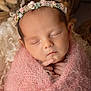 newborn, baby, sleeping, pink_blanket, floral_headband, soft_texture, closeup, portrait, cute, peaceful, infant, wrapped, cozy, delicate, hands, face, resting, adorable, soft_lighting, warm