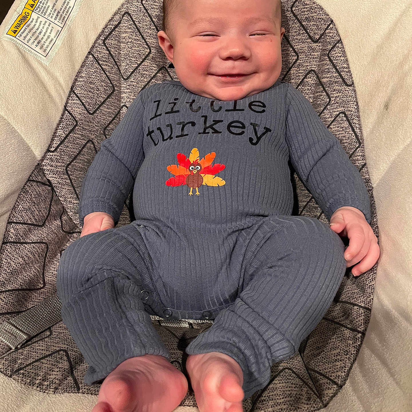 James is registered to the contest to win money with this photo: baby, babylaughing, clothing, crying, cushion, face, furniture, happy, head, homedecor, knitwear, newborn, pants, person, photography, portrait, sad, sitting, smile, sweater
