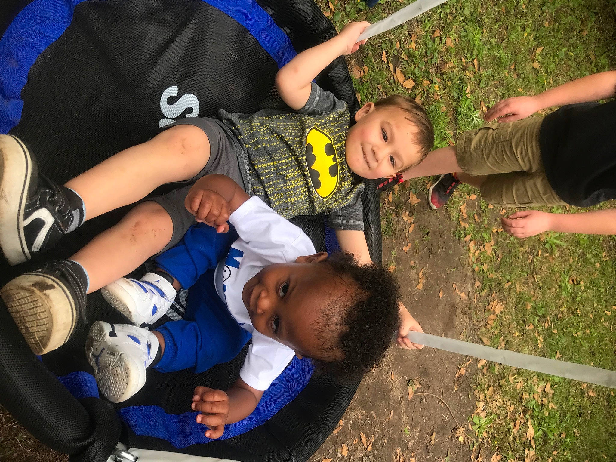 Evan is registered to the contest to win money with this photo: arm, elbow, event, finger, fun, gesture, grass, hand, happy, joy, knee, leg, leisure, person, shorts, sock, sports_uniform, t_shirt, thigh, toddler