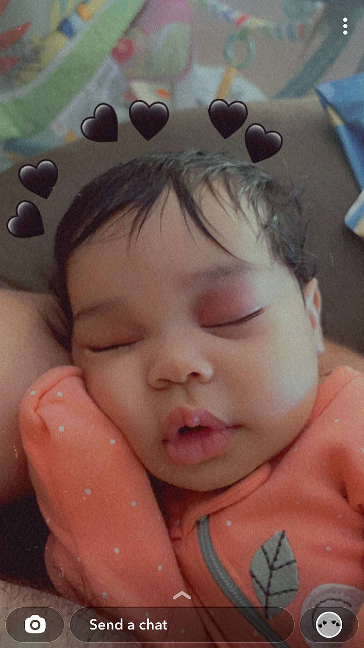 Lucille is registered to the contest to win money with this photo: arm, baby, cheek, chin, comfort, eye, eyebrow, face, forehead, hand, happy, head, headwear, lip, mouth, neck, nose, organ, person, photograph