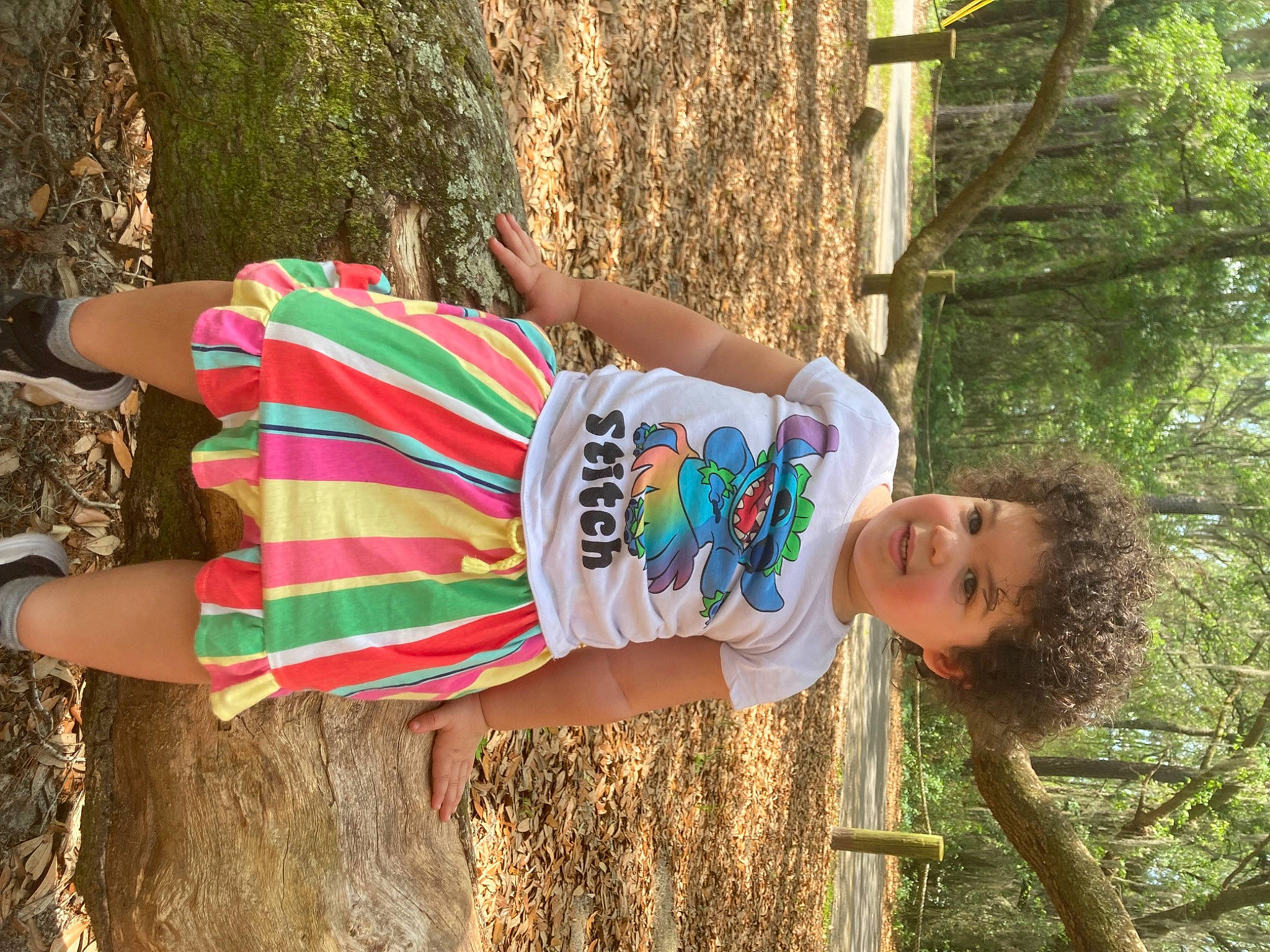 Brooklynn is registered to the contest to win money with this photo: adaptation, clothing, fun, grass, happy, human_leg, joint, leisure, people_in_nature, person, plant, public_space, street_fashion, summer, t_shirt, thigh, tree, trunk, waist, wood