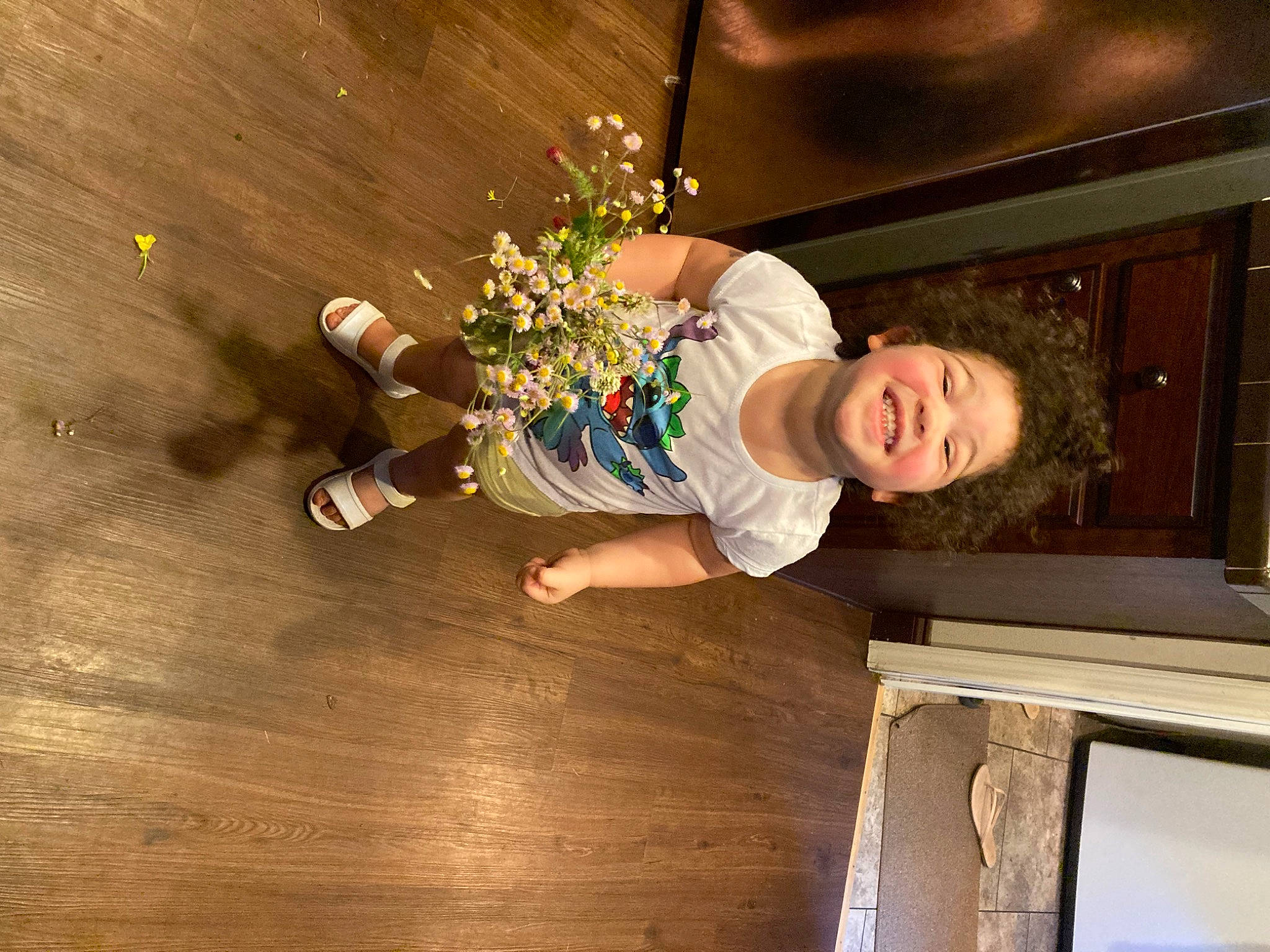 Brooklynn is registered to the contest to win money with this photo: baby, baby_toddler_clothing, child, cut_flowers, flooring, flower, flower_arranging, fun, happy, hardwood, joy, laminate_flooring, person, plant, room, sitting, smile, toddler, varnish, wood