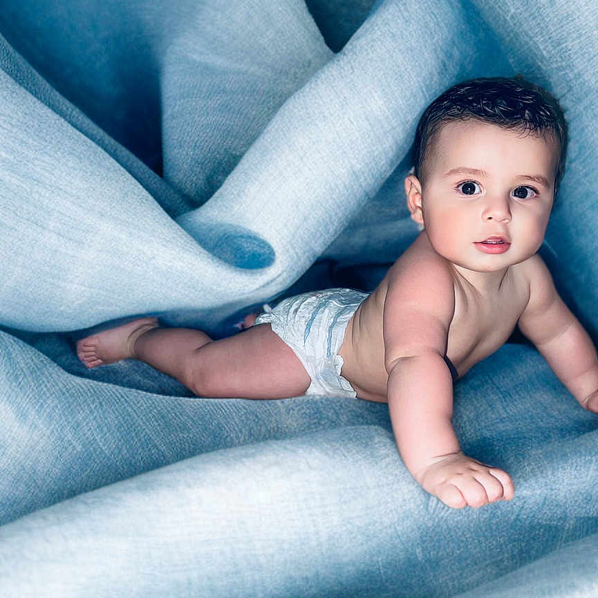 Elijah joined the competition — help win amazing prizes! baby, bed, blanket, bodypart, clothing, crawling, diaper, face, finger, furniture, hand, happy, head, jeans, newborn, pants, person, photography, portrait, smile