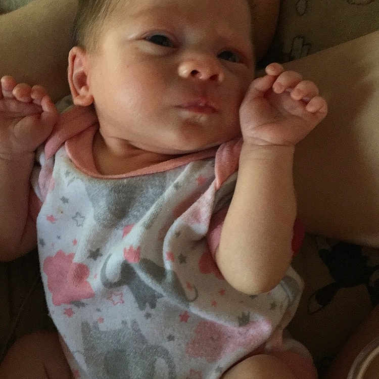 Sarafina is registered to the contest to win money with this photo: baby, baby_toddler_clothing, cheek, chin, comfort, eyebrow, finger, gesture, hand, iris, joint, lip, mouth, neck, nose, shoulder, skin, sleeve, smile, thumb