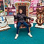 Oscar is registered to the contest to win money with this photo: background, boy, chair, child, christmas, decorations, elves, festive, gingerbread_throne, holiday, jacket, jeans, ornaments, outdoor, pose, reindeer, seasonal, shoes, smiling, snowman