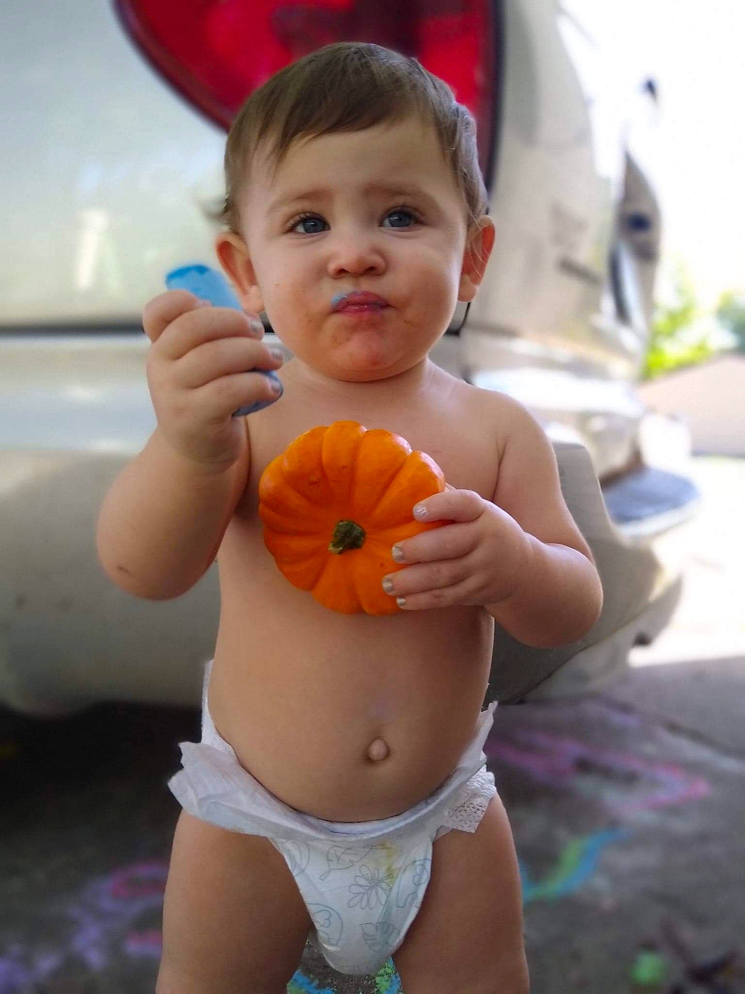 Stormy Love is registered to the contest to win money with this photo: abdomen, baby, bathing, calabaza, cheek, child, finger, fun, hand, leg, leisure, orange, person, plant, play, skin, smile, thumb, toddler, vacation