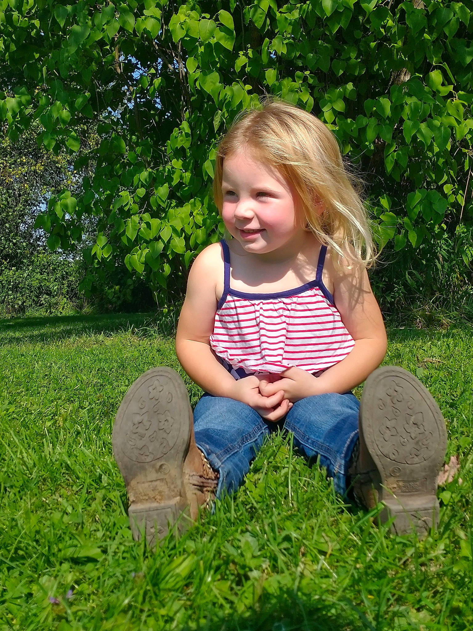 Emma joined the competition — help win amazing prizes! botany, child, facial_expression, fun, grass, grass_family, grassland, groundcover, happy, jeans, joy, leaf, leisure, meadow, people_in_nature, person, plant, sneakers, summer, sunlight