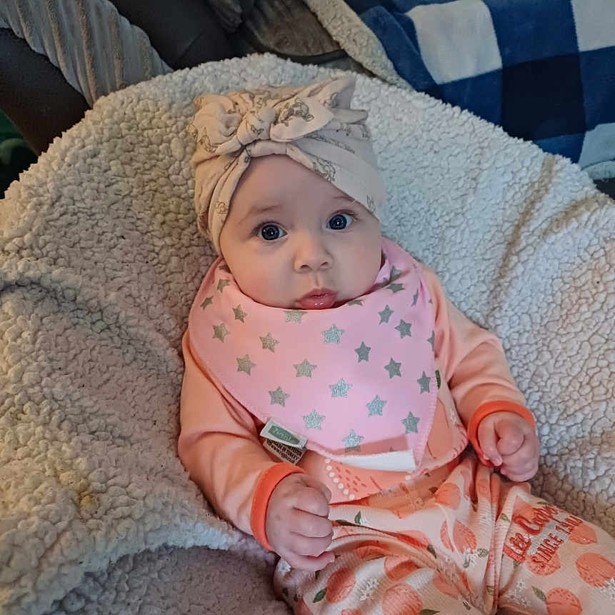 Polly is registered to the contest to win money with this photo: baby, blanket, bonnet, cap, clothing, couch, cushion, face, furniture, hat, head, homedecor, newborn, pants, person, photography, portrait, quilt, sitting, sleeping