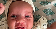 Bianca joined the competition — help win amazing prizes! baby, infant, face, headwrap, bow, drool, expression, blanket, pattern, clothing, cute, child, portrait, skin, eyes, mouth, hand, lying_down, indoors, closeup