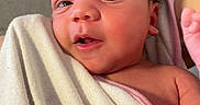 Bianca is registered to the contest to win money with this photo: baby, blanket, closeup, curious, expression, eyes, face, hand, head, indoors, infant, newborn, person, pink, portrait, skin, soft, towel, white, wrapped