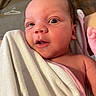 Bianca is registered to the contest to win money with this photo: baby, newborn, infant, face, eyes, skin, blanket, towel, wrapped, curious, expression, indoors, person, portrait, closeup, head, hand, pink, white, soft