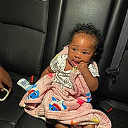 Kehlani joined the competition — help win amazing prizes! baby, blanket, car_seat, child, curly_hair, cute, hand, infant, interior, leather, person, playful, seatbelt, shirt, sitting, skin, small_bottle, toy, vehicle, young_child