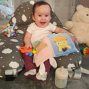Ophelia joined the competition — help win amazing prizes! baby, child, smiling, toy, teddy_bear, bottle, fabric_book, cushion, cloud_pattern, indoor, happy, sitting, infant, playtime, soft_toys, footwear, white_shirt, purple_pants, baby_seat, home