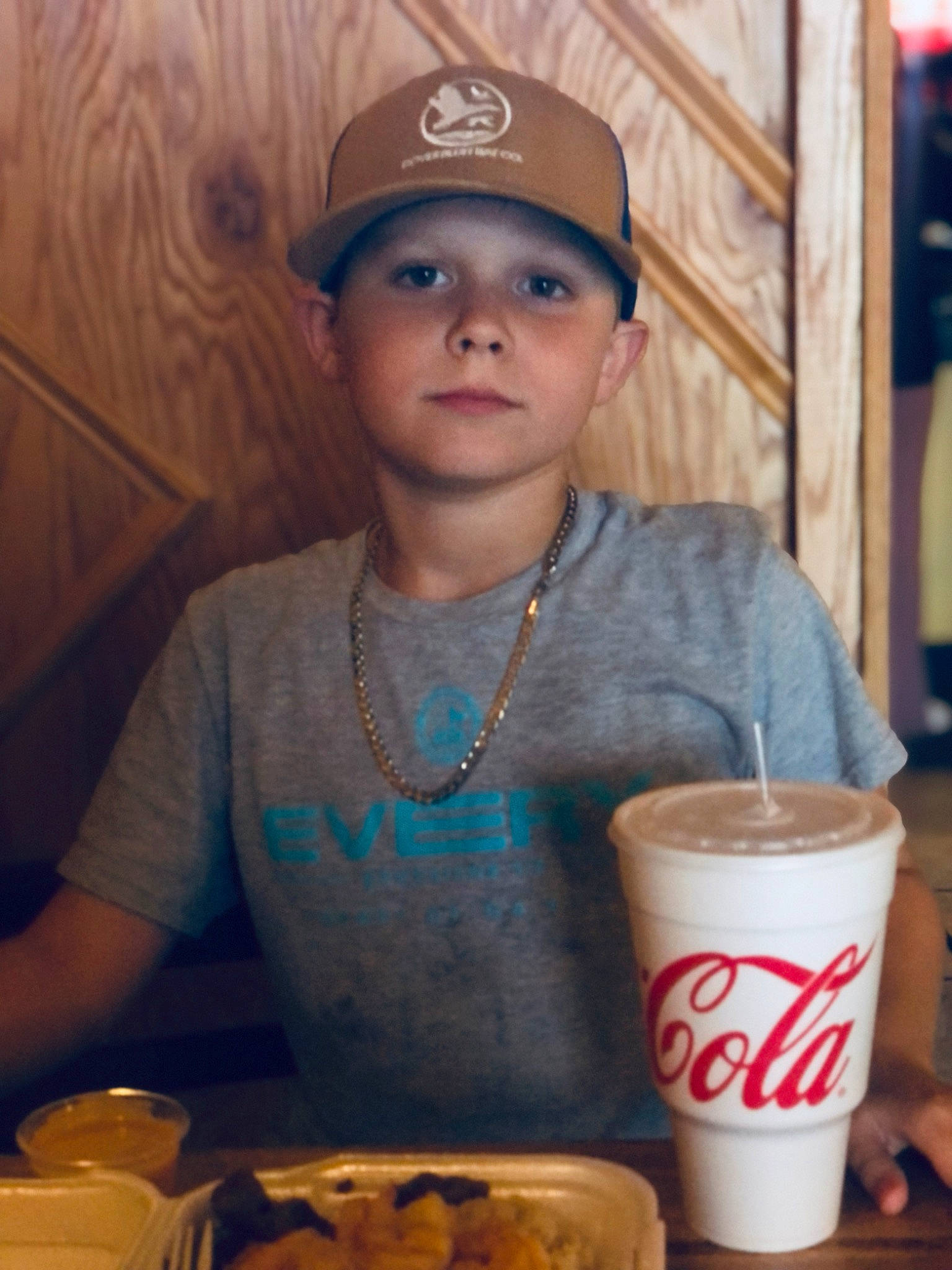 Matthew joined the competition — help win amazing prizes! baseball_cap, cap, chair, child, comfort_food, cup, drink, drinking, drinkware, food, hat, headwear, non_alcoholic_beverage, person, plate, serveware, soft_drink, sweetness, t_shirt, tableware