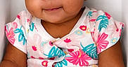 Dream is registered to the contest to win money with this photo: baby, blanket, child, closeup, clothing, curly_hair, cute, eyes, face, floral_pattern, fuzzy, happy, indoors, infant, onesie, portrait, sitting, skin, smile, soft_light