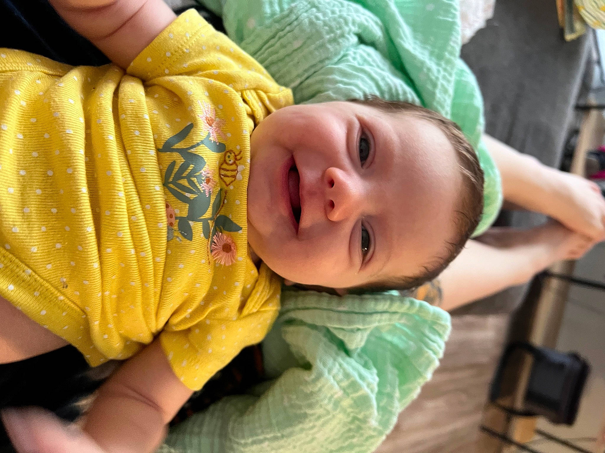 River is registered to the contest to win money with this photo: arm, baby, baby_products, baby_toddler_clothing, cheek, child, comfort, eye, finger, hand, happy, head, mouth, nose, person, skin, sleeve, smile, thumb, toddler