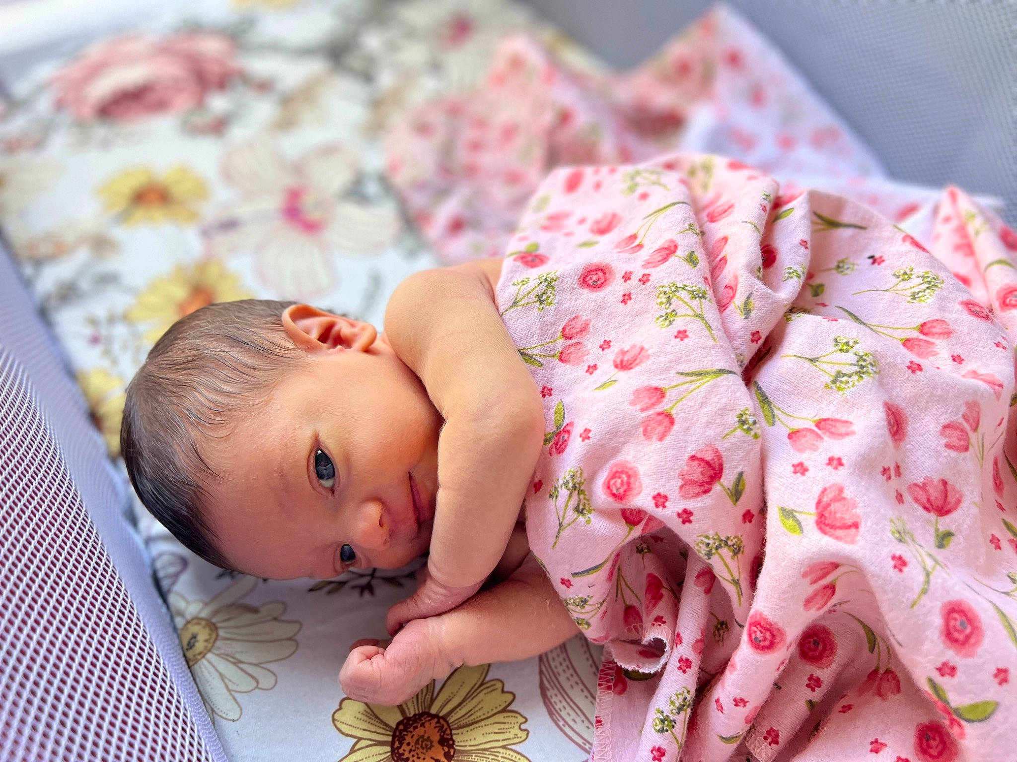 River is registered to the contest to win money with this photo: arthropod, baby, baby_toddler_clothing, butterfly, comfort, face, happy, head, human_body, insect, linens, pattern, person, pink, pollinator, red, skin, sleeve, textile, toddler