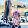 Lakelynn joined the competition — help win amazing prizes! child, toddler, hat, bucket_hat, smiling, outdoor, backyard, fence, patio, chair, umbrella, sunny, daytime, clothing, shorts, tshirt, person, happy, playful, house