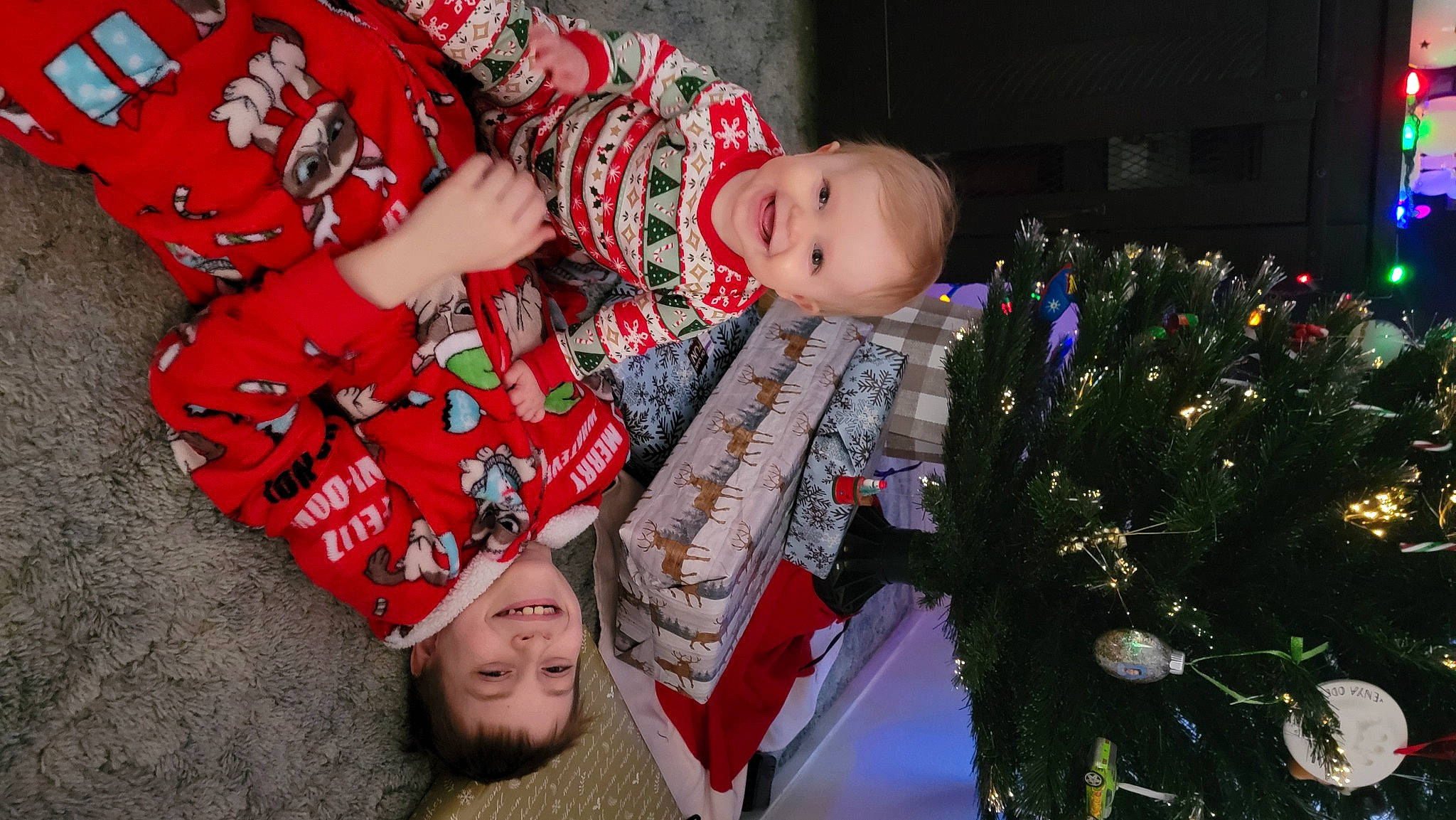 Enya is registered to the contest to win money with this photo: baby, baby_toddler_clothing, child, christmas, christmas_ornament, christmas_tree, event, fun, happy, head, holiday, joy, organ, pattern, person, plant, red, sitting, smile, toddler